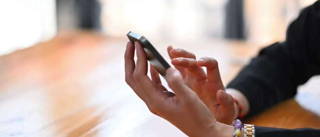close up view of businesswoman using mobile phone utc